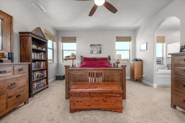 2653 Vermont Ave, Clovis, CA 93619 - bedroom featuring light carpet, arched walkways, multiple windows, and baseboards