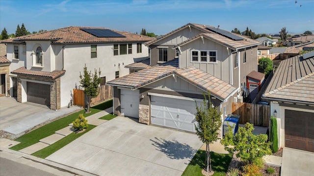 2653 Vermont Ave, Clovis, CA 93619 - view of front of property featuring board and batten siding, a garage, driveway, and solar panels