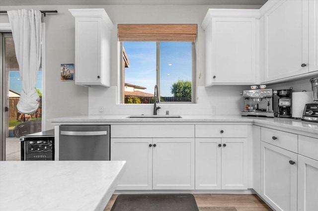 2653 Vermont Ave, Clovis, CA 93619 - kitchen featuring a sink, stainless steel dishwasher, white cabinets, and tasteful backsplash