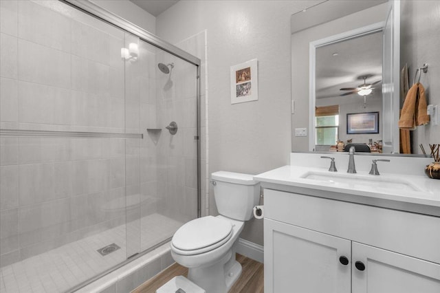 2653 Vermont Ave, Clovis, CA 93619 - full bath with toilet, vanity, a shower stall, wood finished floors, and a ceiling fan