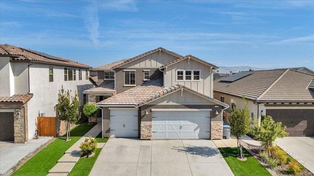 2653 Vermont Ave, Clovis, CA 93619 - view of front facade with board and batten siding, stone siding, concrete driveway, and fence