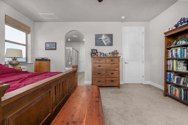 2653 Vermont Ave, Clovis, CA 93619 - bedroom featuring arched walkways, light colored carpet, baseboards, and ensuite bathroom