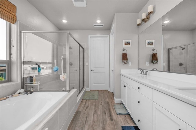 2653 Vermont Ave, Clovis, CA 93619 - full bath featuring a stall shower, wood finished floors, a bath, double vanity, and recessed lighting
