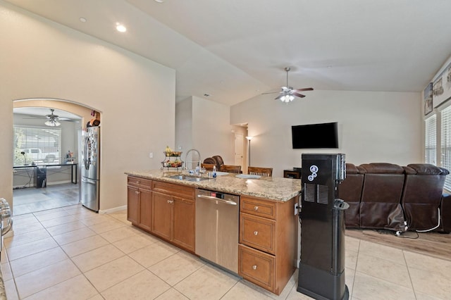 kitchen with ceiling fan, lofted ceiling, stainless steel appliances, and a sink