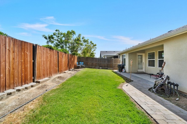 view of yard with a fenced backyard and a patio