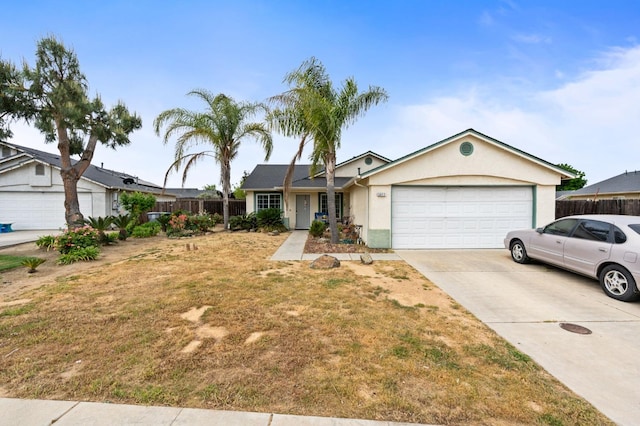 3617 Clay Ct, Selma, CA 93662 - ranch-style home with driveway, an attached garage, fence, a front yard, and stucco siding