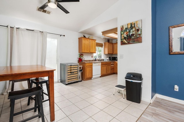 3617 Clay Ct, Selma, CA 93662 - kitchen with vaulted ceiling, white dishwasher, black microwave, beverage cooler, and visible vents
