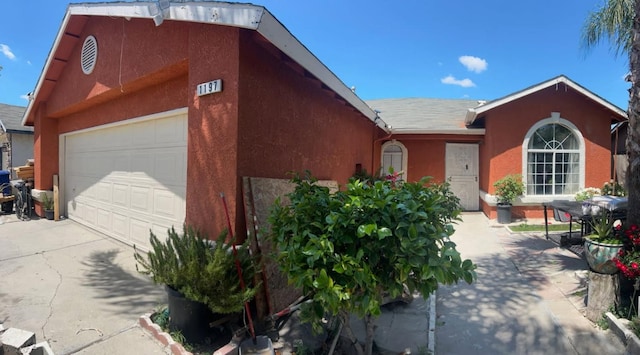 1197 Mulberry, Parlier, CA 93648 - view of front of house featuring an attached garage, driveway, and stucco siding