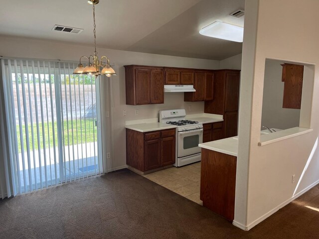 1836 Heidi Ave, Sanger, CA 93657 - kitchen featuring under cabinet range hood, a healthy amount of sunlight, visible vents, and gas range gas stove