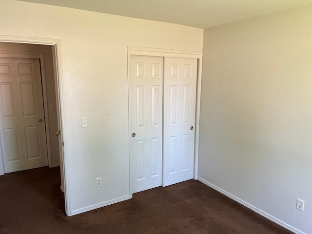 1836 Heidi Ave, Sanger, CA 93657 - unfurnished bedroom with dark colored carpet, a closet, and baseboards