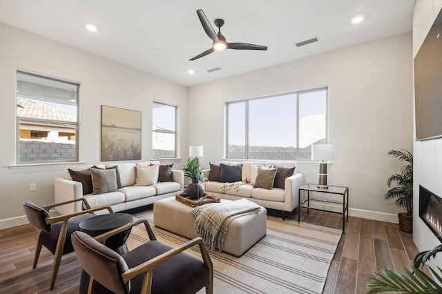 11182 N Via Ravenna Dr, Fresno, CA 93730 - living area featuring wood finished floors, ceiling fan, baseboards, visible vents, and recessed lighting