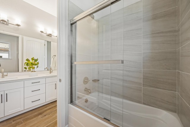 11182 N Via Ravenna Dr, Fresno, CA 93730 - full bathroom with wood finished floors, a sink, double vanity, and combined bath / shower with glass door