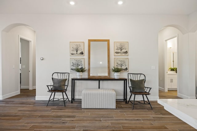 11182 N Via Ravenna Dr, Fresno, CA 93730 - living area with arched walkways, radiator, baseboards, recessed lighting, and wood finished floors