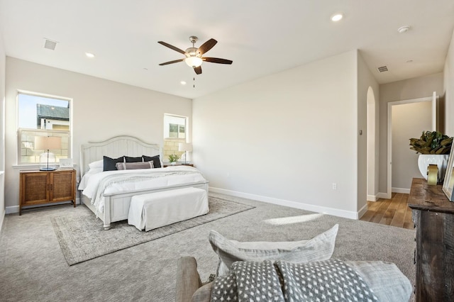 11182 N Via Ravenna Dr, Fresno, CA 93730 - bedroom with arched walkways, baseboards, and multiple windows