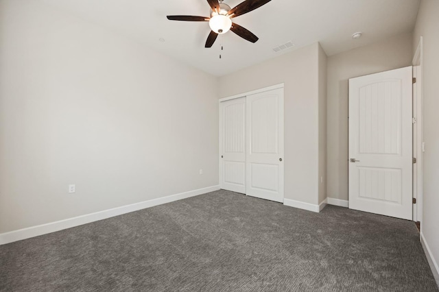 11182 N Via Ravenna Dr, Fresno, CA 93730 - unfurnished bedroom with dark carpet, visible vents, a closet, baseboards, and ceiling fan