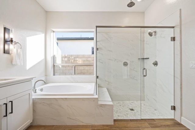 11182 N Via Ravenna Dr, Fresno, CA 93730 - bathroom featuring a bath, vanity, wood tiled floor, and a marble finish shower