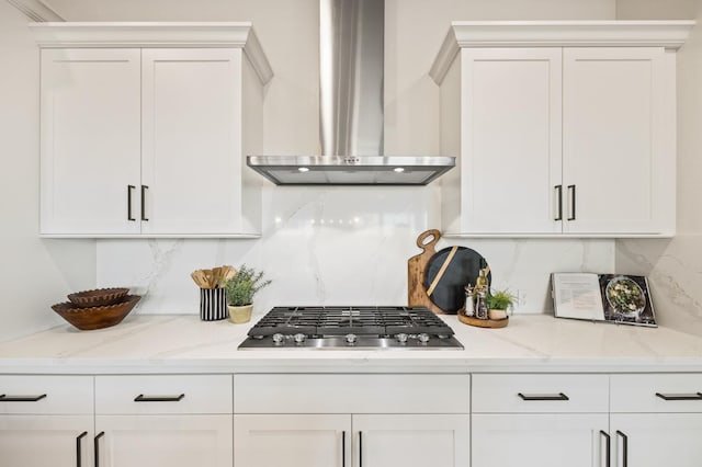11182 N Via Ravenna Dr, Fresno, CA 93730 - kitchen featuring wall chimney exhaust hood, white cabinetry, tasteful backsplash, and stainless steel gas stovetop