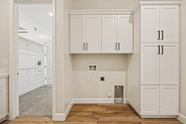 11182 N Via Ravenna Dr, Fresno, CA 93730 - laundry room featuring wood finished floors, baseboards, electric dryer hookup, cabinet space, and washer hookup