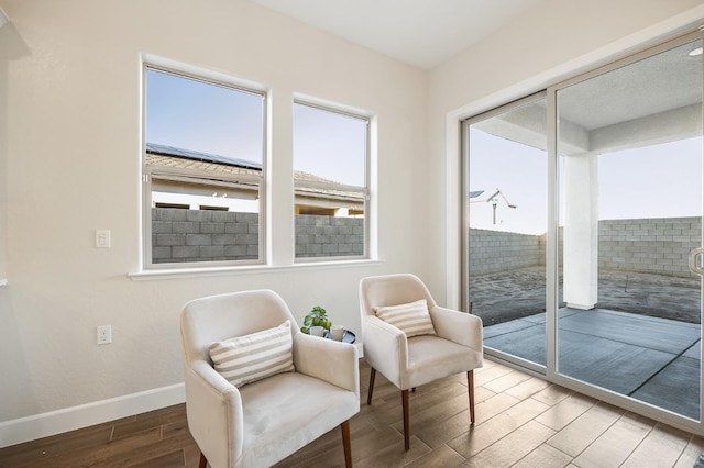 11182 N Via Ravenna Dr, Fresno, CA 93730 - living area featuring baseboards, wood finished floors, and a wealth of natural light
