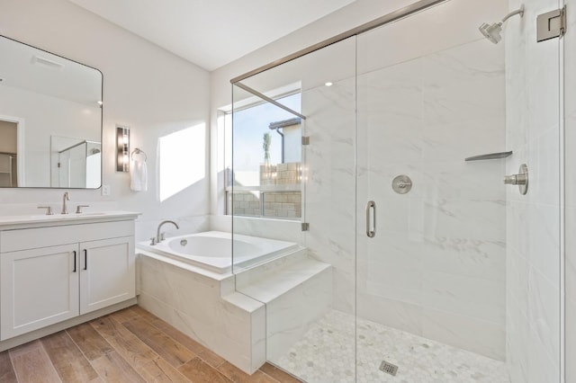 11182 N Via Ravenna Dr, Fresno, CA 93730 - full bathroom with a shower stall, a garden tub, vanity, and wood finished floors