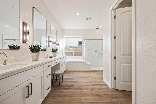 11182 N Via Ravenna Dr, Fresno, CA 93730 - full bathroom with a shower stall, wood finished floors, visible vents, vanity, and a bath