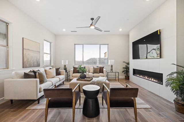 11182 N Via Ravenna Dr, Fresno, CA 93730 - living room featuring visible vents, recessed lighting, a ceiling fan, wood finished floors, and a fireplace