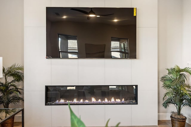 11182 N Via Ravenna Dr, Fresno, CA 93730 - interior details with a ceiling fan and a glass covered fireplace