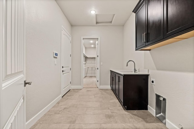6294 E Miillie Dr, Fresno, CA 93727 - laundry area featuring baseboards, a sink, hookup for an electric dryer, and cabinet space
