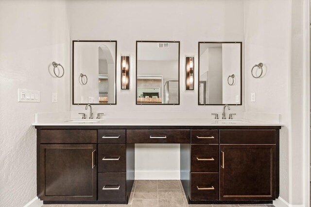6294 E Miillie Dr, Fresno, CA 93727 - bathroom with baseboards, a sink, and double vanity