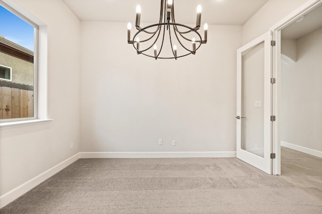 6294 E Miillie Dr, Fresno, CA 93727 - unfurnished dining area featuring carpet, an inviting chandelier, and baseboards