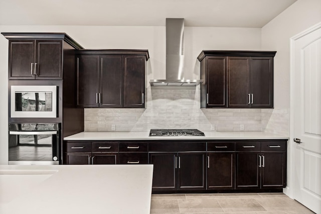 6294 E Miillie Dr, Fresno, CA 93727 - kitchen with light countertops, wall chimney exhaust hood, oven, and stainless steel gas cooktop