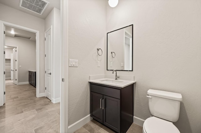 6294 E Miillie Dr, Fresno, CA 93727 - bathroom with baseboards, visible vents, toilet, and vanity