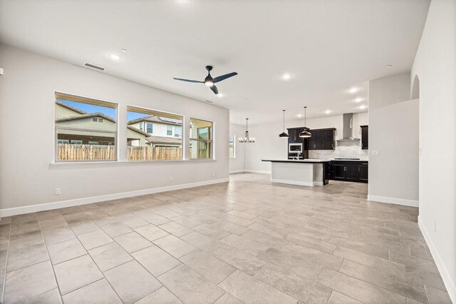 6294 E Miillie Dr, Fresno, CA 93727 - unfurnished living room featuring baseboards, recessed lighting, visible vents, and ceiling fan with notable chandelier