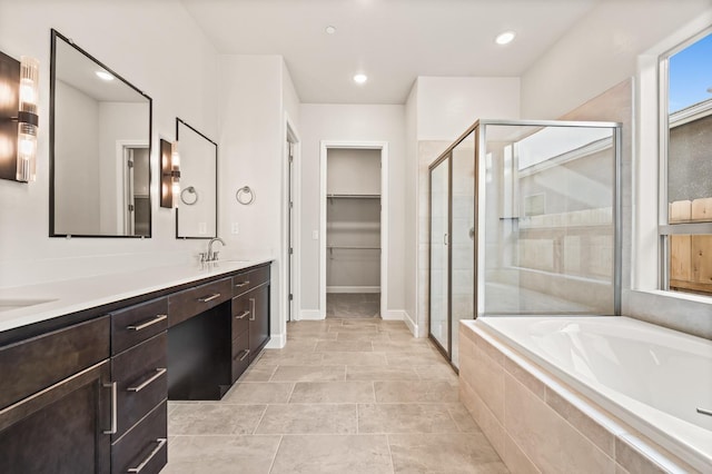 6294 E Miillie Dr, Fresno, CA 93727 - bathroom featuring a garden tub, a sink, double vanity, and a stall shower