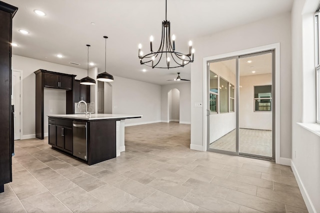 6294 E Miillie Dr, Fresno, CA 93727 - kitchen featuring recessed lighting, an island with sink, light countertops, a sink, and arched walkways
