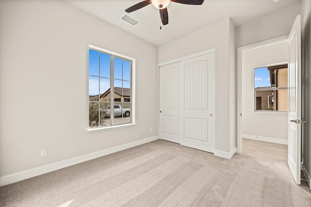 6294 E Miillie Dr, Fresno, CA 93727 - unfurnished bedroom featuring carpet floors, multiple windows, visible vents, and a closet
