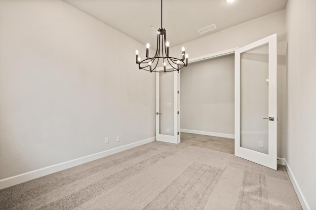 6294 E Miillie Dr, Fresno, CA 93727 - unfurnished dining area with visible vents, french doors, baseboards, carpet flooring, and a notable chandelier