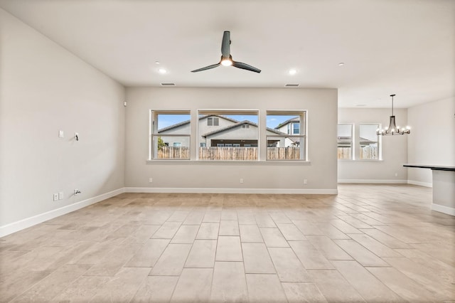 6294 E Miillie Dr, Fresno, CA 93727 - unfurnished living room featuring baseboards, a wealth of natural light, visible vents, and ceiling fan with notable chandelier