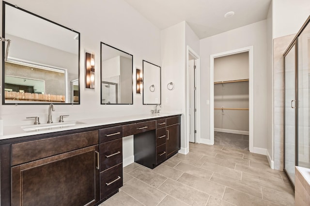 6294 E Miillie Dr, Fresno, CA 93727 - full bath with a shower stall, a sink, a spacious closet, and double vanity
