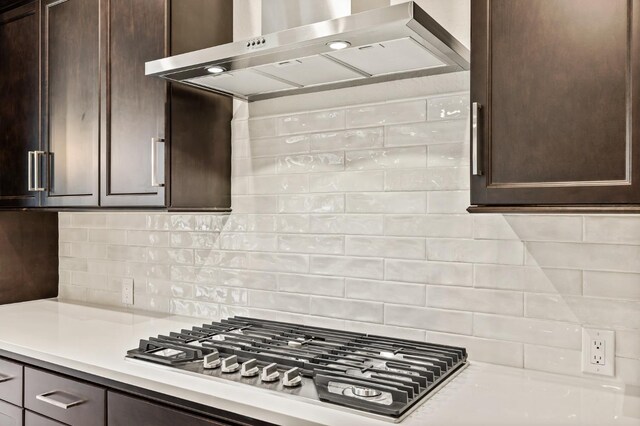 6294 E Miillie Dr, Fresno, CA 93727 - kitchen featuring wall chimney range hood, dark brown cabinets, stainless steel gas stovetop, decorative backsplash, and light countertops