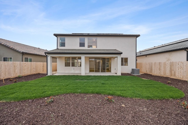 rear view of house with a patio, a fenced backyard, central air condition unit, and stucco siding