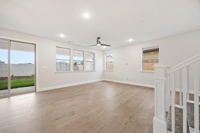 unfurnished living room featuring recessed lighting, light wood finished floors, visible vents, stairs, and ceiling fan