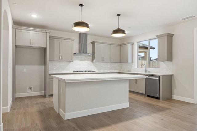 kitchen featuring backsplash, dishwasher, wall chimney exhaust hood, and gray cabinetry