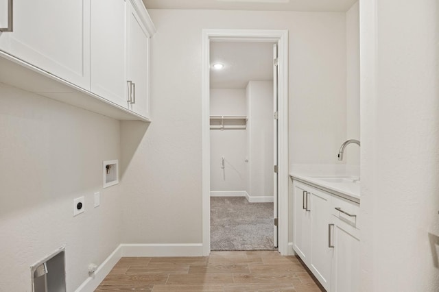 4288 N Phoenix, Fresno, CA 93723 - washroom featuring cabinet space, hookup for an electric dryer, washer hookup, and light wood finished floors