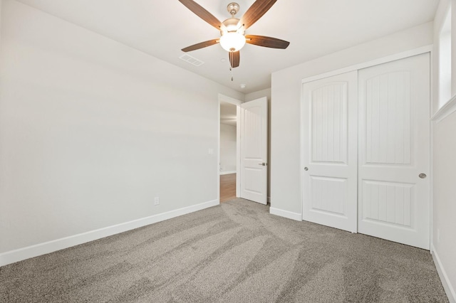 unfurnished bedroom with visible vents, baseboards, carpet flooring, and a closet