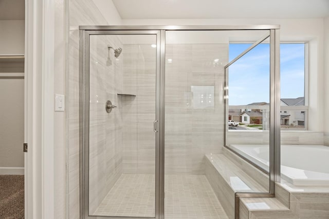 bathroom with a garden tub and a stall shower