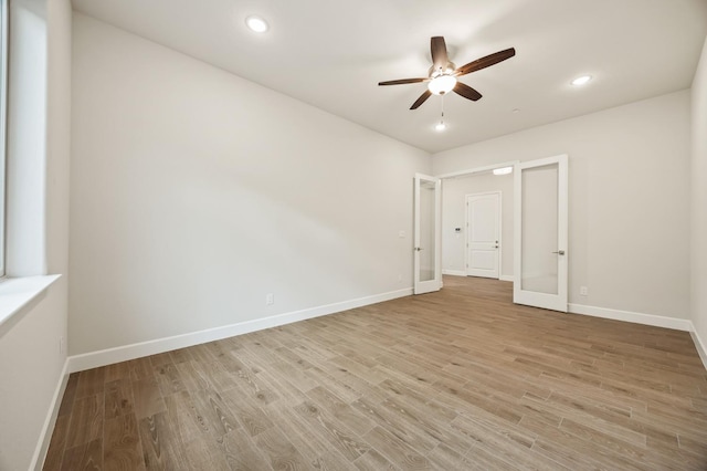 unfurnished bedroom with recessed lighting, light wood-style floors, and baseboards