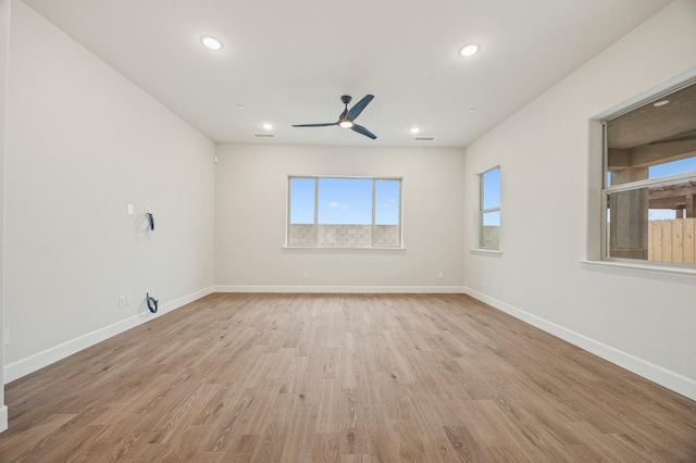 empty room featuring recessed lighting, light wood finished floors, baseboards, and a ceiling fan
