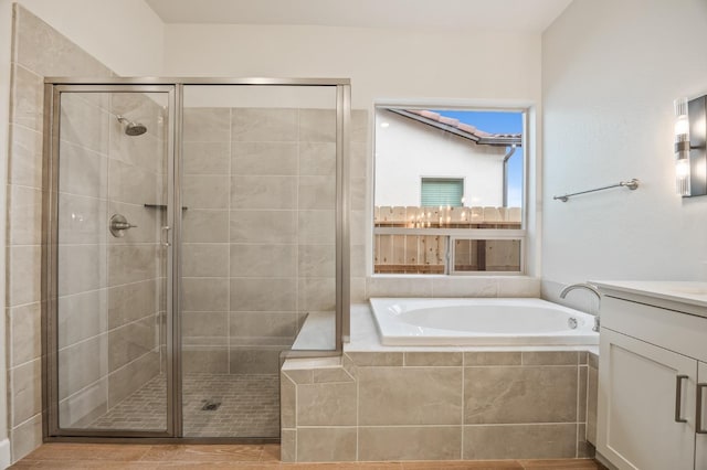 full bath with a shower stall, a garden tub, and vanity