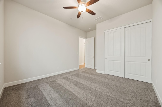 unfurnished bedroom featuring baseboards, visible vents, and carpet